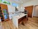 Gourmet kitchen features an oversized island, stainless appliances, custom cabinets and wine storage at 2408 Nassau St, Sarasota, FL 34231
