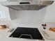Modern kitchen with smooth top range, sleek hood vent, and white backsplash at 2408 Nassau St, Sarasota, FL 34231