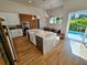 Bright, modern kitchen with island, white cabinets, stainless appliances, and light wood floors at 2408 Nassau St, Sarasota, FL 34231