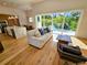 Bright living room with modern furnishings, open floor plan, and sliding glass doors leading to outdoor living space at 2408 Nassau St, Sarasota, FL 34231