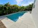 Inviting pool surrounded by lush tropical foliage and stylish tile, perfect for relaxation at 2408 Nassau St, Sarasota, FL 34231