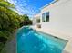 Enjoy a refreshing swim in this backyard pool surrounded by tropical landscaping with stunning views at 2408 Nassau St, Sarasota, FL 34231