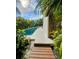 The backyard pool features stone pavers, and lush tropical landscaping at 2408 Nassau St, Sarasota, FL 34231