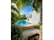 Backyard pool offers a serene escape with a white exterior and mature landscaping at 2408 Nassau St, Sarasota, FL 34231