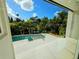 View of the pool and lush landscaping beyond the glass doors creating indoor-outdoor living at 2408 Nassau St, Sarasota, FL 34231