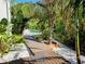 Backyard pool with exotic palm trees and a wooden path leading up to the pool area at 2408 Nassau St, Sarasota, FL 34231