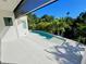 Backyard with a sleek pool and lush tropical foliage, offering a private and serene oasis at 2408 Nassau St, Sarasota, FL 34231