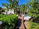 Charming walkway with wooden posts and manicured hedges, leading to the home at 2408 Nassau St, Sarasota, FL 34231