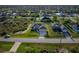 Aerial view of a suburban neighborhood featuring green lawns and houses on spacious lots at 9257 King Hill St, Port Charlotte, FL 33981
