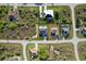 Aerial view showcasing multiple homes, lush landscapes, and neighborhood streets at 9257 King Hill St, Port Charlotte, FL 33981