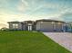 Beautiful single-story home featuring a paver driveway, well-manicured lawn, and a three car garage at 9257 King Hill St, Port Charlotte, FL 33981