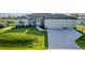 Charming single-story home features lush front yard, paved driveway, and a welcoming entrance at 9257 King Hill St, Port Charlotte, FL 33981