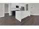 Modern kitchen features white cabinetry, stainless steel appliances and center island with quartz countertops at 9257 King Hill St, Port Charlotte, FL 33981