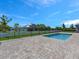 Serene backyard with a refreshing swimming pool and paver patio, enclosed by a secure metal fence for privacy at 9257 King Hill St, Port Charlotte, FL 33981