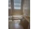 Cozy bathroom features a shower-tub combo with neutral tiles and bright natural light at 1452 Crazy Horse Dr, Lutz, FL 33559
