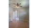Bedroom featuring a ceiling fan, neutral walls, with doorways to other rooms at 1452 Crazy Horse Dr, Lutz, FL 33559