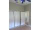 Bedroom with double closet and doorway access to other rooms at 1452 Crazy Horse Dr, Lutz, FL 33559