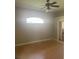 Cozy bedroom with neutral walls, a ceiling fan, and natural light from a large window at 1452 Crazy Horse Dr, Lutz, FL 33559