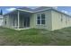 Exterior view of home highlighting the back of the house with sliding door at 1452 Crazy Horse Dr, Lutz, FL 33559