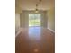 Bright and airy living room featuring a sliding glass door leading to the outdoors at 1452 Crazy Horse Dr, Lutz, FL 33559