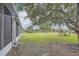 Large green grass backyard with mature trees at 26622 Castleview Way, Wesley Chapel, FL 33544