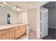 Bright bathroom boasts double sinks, vanity storage, and a mirror with updated lighting fixtures at 26622 Castleview Way, Wesley Chapel, FL 33544