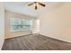 A carpeted bedroom featuring neutral walls and a large window at 26622 Castleview Way, Wesley Chapel, FL 33544