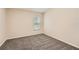 Cozy bedroom with a large window offering ample natural light and plush carpeting at 26622 Castleview Way, Wesley Chapel, FL 33544