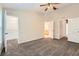 Spacious bedroom featuring plush carpeting, neutral paint, and high ceilings with a modern ceiling fan at 26622 Castleview Way, Wesley Chapel, FL 33544