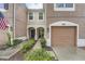 Two-story townhome with a one-car garage and landscaped walkway at 26622 Castleview Way, Wesley Chapel, FL 33544