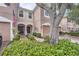 Two-story townhome with a one-car garage and landscaped front yard and entryway at 26622 Castleview Way, Wesley Chapel, FL 33544