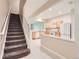 Interior view of stairs leading to kitchen with wood cabinets and white appliances at 26622 Castleview Way, Wesley Chapel, FL 33544