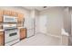 A clean kitchen featuring light wood cabinets and white appliances at 26622 Castleview Way, Wesley Chapel, FL 33544