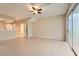 Bright living room with tile floors and sliding glass doors to the backyard at 26622 Castleview Way, Wesley Chapel, FL 33544