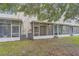 A pleasant, screened-in back patio area with a grassy lawn adds to the property's outdoor charm at 26622 Castleview Way, Wesley Chapel, FL 33544