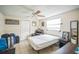 Neutral bedroom with a large window, a ceiling fan, and a comfortable bed, creating a cozy and bright atmosphere at 1711 E Sewaha St, Tampa, FL 33612