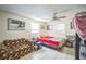 Comfortable bedroom featuring a cozy couch, a ceiling fan, a bright window, and tile flooring at 1711 E Sewaha St, Tampa, FL 33612