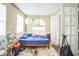 Bright bedroom featuring a large window, a globe light, and an unique flower arrangement, creating a serene space at 1711 E Sewaha St, Tampa, FL 33612