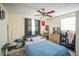 Comfortable bedroom with a ceiling fan, a dresser, and a large window, creating a relaxing atmosphere at 1711 E Sewaha St, Tampa, FL 33612