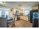 Functional kitchen with wood-look floors, white cabinets, black appliances, and ample counter space at 1711 E Sewaha St, Tampa, FL 33612