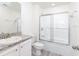 Bright bathroom featuring a shower-tub combo, granite countertops, and modern fixtures at 23461 Wickens Ave, Port Charlotte, FL 33980