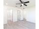 Bright bedroom featuring a ceiling fan, with open door to the bathroom, and vinyl flooring at 23461 Wickens Ave, Port Charlotte, FL 33980