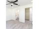 Bright bedroom with en suite bathroom featuring ceiling fan, and vinyl flooring at 23461 Wickens Ave, Port Charlotte, FL 33980