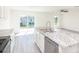 Kitchen featuring granite countertops and stainless steel appliances with a sliding glass door view to the backyard at 23461 Wickens Ave, Port Charlotte, FL 33980