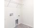 Cozy laundry area, featuring ample lighting, shelving and space for washer and dryer at 23461 Wickens Ave, Port Charlotte, FL 33980