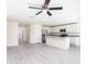 Open floor plan with kitchen, stainless steel appliances, and spacious living area with ceiling fan at 23461 Wickens Ave, Port Charlotte, FL 33980