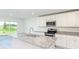 Bright kitchen features granite countertops, stainless steel appliances, and ample cabinet space at 3124 N Chamberlain Blvd, North Port, FL 34286