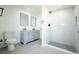 Bright bathroom featuring double vanity, shower with white tiling and mosaic flooring at 5907 Sussex Ct, Tampa, FL 33615