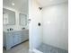 Bathroom featuring double vanity, walk-in shower with modern fixtures, and tile accents at 5907 Sussex Ct, Tampa, FL 33615