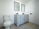 Bright bathroom with a double vanity, modern fixtures, and a tile floor at 5907 Sussex Ct, Tampa, FL 33615